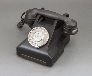 A black Bakelite dial telephone 