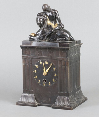 An Edwardian French timepiece contained in a cast metal case surmounted by a figure of a gentleman seat upon a sphinx 28cm h x 16cm w x 12cm d 