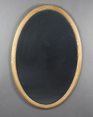 A 19th Century oval bevelled plate wall mirror contained a ribbon and reeded ball studded gilt frame 94cm x 64cm (silvering to the mirror is showing signs of deterioration, frame a/f)