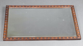 A rectangular bevelled plate wall mirror contained in a carved oak frame 79cm x 52cm 