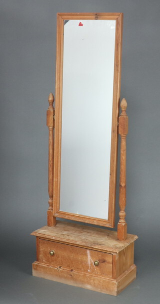 A rectangular plate cheval mirror contained in a pine frame, fitted a drawer to the base 163cm h x 61cm w x 28cm d (pitting and contact marks in places)