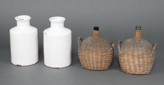 A pair of cylindrical white crazed and glazed flagons/vases 38cm together with 2 wicker covered spirit bottles (1 handle f)  