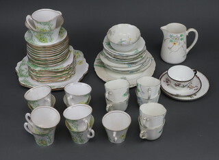 An Art Deco Roslyn part tea service comprising 9 tea cups, 12 saucers, 11 side plates, 2 serving plates, a milk jug and minor teaware