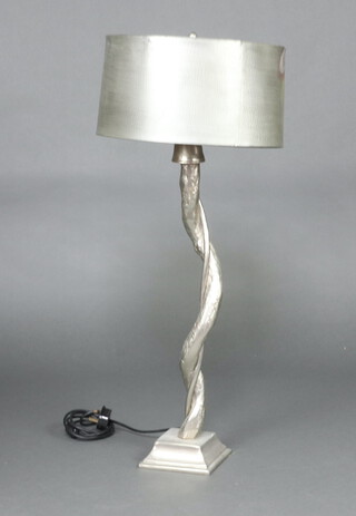 A silver metal table lamp in the form of a tree, raised on a square base 68cm h 