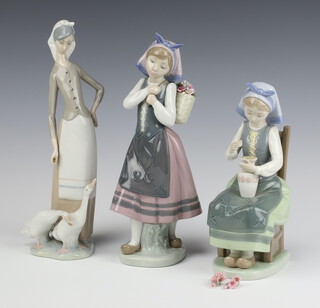 A Lladro figure of a standing girl with basket of flowers, base impressed E18E 25cm (minor chips to petals), ditto seated girl with vase of flowers C-250 22cm (flowers a/f), standing girl with geese 27cm (something missing from right hand) , all boxed 