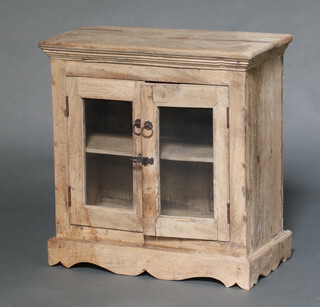 An Eastern bleached hardwood cabinet enclosed by glazed panelled doors 61cm h x 61cm w x 29cm d 