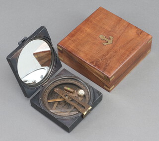 A reproduction compass contained in a hardwood box 