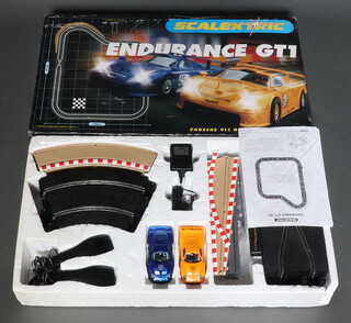 A boxed Scalextric Endurance Porsche GTI set (box with original polystyrene.  Controller, track, cars, power supply and instructions are present) 