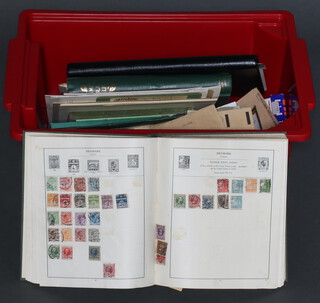 An album of GB mint and used stamps - George V to Elizabeth II, a green standard album of world stamps and loose stamps some on paper, (contained in a red plastic crate)  