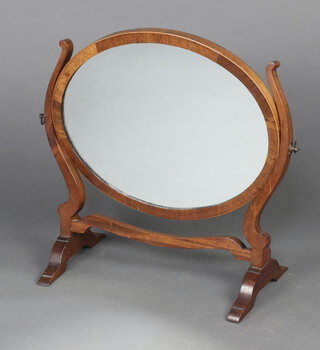 A 19th Century oval plate dressing table mirror contained in a mahogany swing frame 43cm h x 48cm 