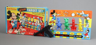 Welsotoys, a Walt Disney Action Target set shooting gallery game complete with gun, shooting gallery and 6, original corks, boxed (gallery, urn and corks are in excellent condition, the box has a 4" tear to the top right hand corner)