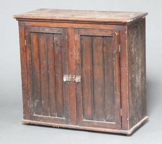 A Victorian pine cabinet with shelved interior enclosed by a pair of panelled doors 83cm h x 89cm w x 41cm d (top loose) 