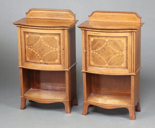 A pair of Edwardian inlaid mahogany bow front bedside cabinets with raised backs and recess, raised on bracket feet 75cm h x 44cm w x 25cm d (Water and contact marks in places)  