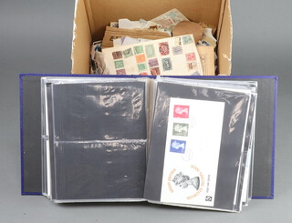 An album of 1960/70's GB first day covers and a collection of loose stamps, mint and used, some on paper 