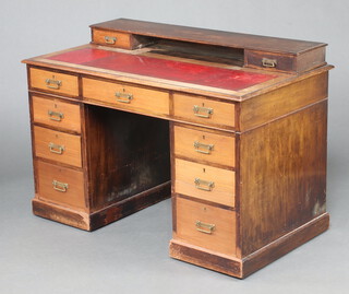 A Victorian oak desk with raised back and red inset writing surface above 1 long and 8 short drawers on a platform base 84cm h x 122cm w x 67cm d (all in one piece, contact marks in places)