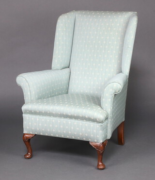 A Georgian style wing armchair upholstered in blue material, raised on cabriole supports 102cm h x 86cm w x 67cm (seat 30cm x 37cm) 