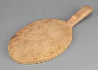 Robert "Mouseman" Thompson of Kilburn, an oak cheeseboard, the handle with carved mouse, circa 1975 36cm x 17cm 