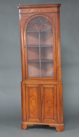 A Georgian inlaid mahogany double corner cabinet, the upper section with moulded cornice, fitted shelves enclosed by astragal glazed panelled doors, the base enclosed by a pair of quarter veneered panelled doors with Prince of Wales feathers, raised on bracket feet 221cm h x 56cm w x 80cm d  