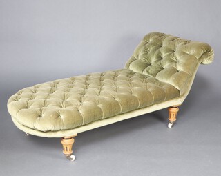 A Victorian scroll arm chaise longue upholstered in green material, raised on turned supports 68cm h x 174cm w x 63cm d (seat 100cm x 46cm) 