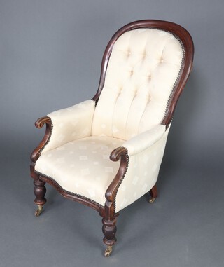 A Victorian mahogany show frame armchair upholstered in white buttoned material, raised on turned supports 104cm h x 58cm w x 55cm d 