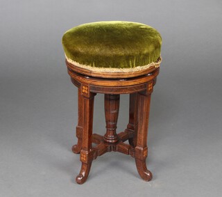 An Edwardian inlaid mahogany revolving piano stool upholstered in green material 47cm h x 32cm diam. 