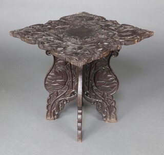 A 19th Century deeply carved Indian hardwood table, the top with floral carving raised on a folding base 64cm h x 62cm w x 60cm d 