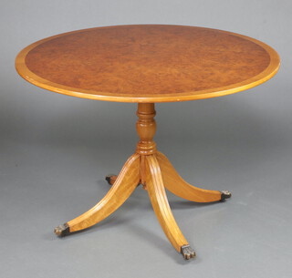 A Georgian style circular figured walnut and crossbanded breakfast table raised on turned supports with platform base 76cm h x 127cm diam. 