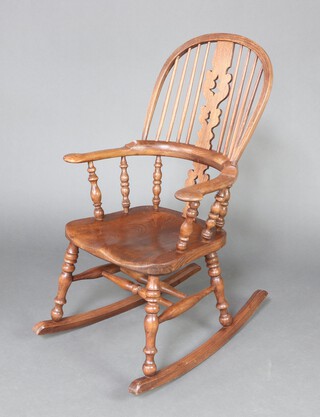 Barry Murphy of Windmill Hill East Sussex, an 18th Century style turned elm rocking Windsor chair 110cm h x 63cm w x 86cm d (seat 24cm x 26cm), contact marks in places, base impressed BMM and labelled Barry Murphy 