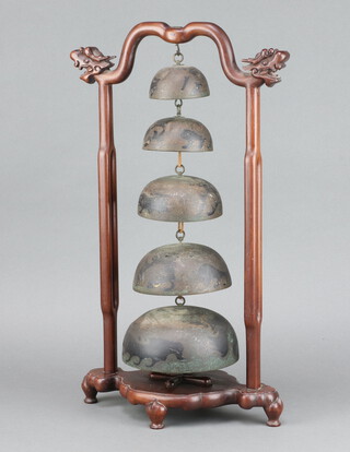 A 19th/20th Century Chinese metal 5 tier table bell, hung on a hardwood stand with dragon decoration 51cm h x 28cm w x 18cm d 