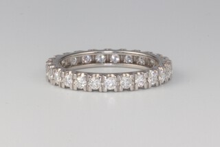 A white metal diamond eternity ring size O, 2.6 grams 