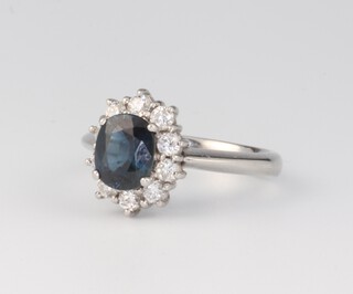 A platinum oval sapphire and diamond cluster ring, the sapphire 1.2ct, the diamonds 0.5ct, size N, 6.5 grams 