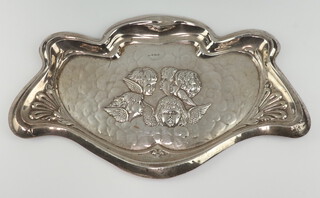 An Edwardian repousse silver serpentine dressing table tray with Reynolds angels decoration Birmingham 1905, maker A E Goodby & Son 38cm, 234 grams 