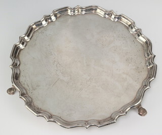 A silver salver with pie crust rim on hoof feet, Sheffield 1914, maker Hawksworth, Eyre & Co Ltd 26cm, 422 grams 