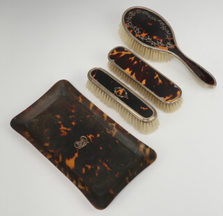 A silver and tortoiseshell hair brush Birmingham 1915, 2 similar clothes brushes and a tray 