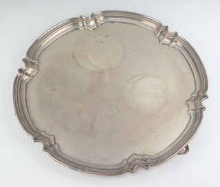 A silver salver with pie crust rim on hoof feet, with presentation inscription, Sheffield 1961, maker Cooper Brothers & Sons Ltd 36cm, 1256 grams 