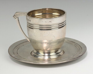 An Art Deco silver mug with ribbed decoration and matching saucer Birmingham 1934, James Dixon & Son Ltd 150 grams 