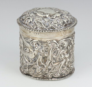 A Victorian repousse silver circular box decorated with birds and scrolls, London 1893, maker Corke Brothers & Co 7cm, 127 grams