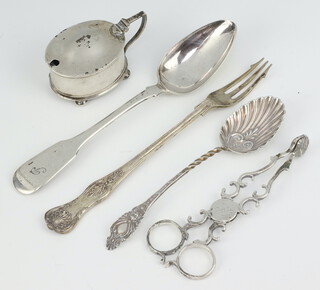 A pair of Georgian silver sugar nips with shell bowls, 2 tea spoons, a fork and a mustard, 186 grams 