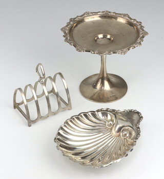 An Edwardian silver shell shaped butter dish Birmingham 1902, a 5 bar toast rack and a tazza, 242 grams 