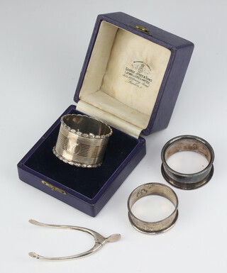 A pair of Edwardian silver wishbone sugar nips, Sheffield 1904, 3 napkin rings 70 grams 