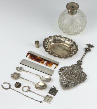 A silver dish with pierced decoration and engraving, London 1957, together with a silver mounted scent, Continental server, 2 teaspoons, 5 charms and a comb, weighable silver 171 grams 