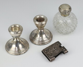 A pair of silver dwarf candlesticks Birmingham 1981 7cm, a mounted scent and cigarette holder 