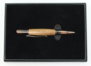 A ballpoint pen made from used oak salvaged from HMS Victory with lacquered metal mounts boxed and with certificate 