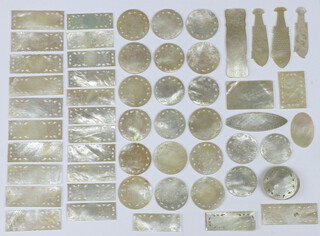 Sixty three Chinese mother of pearl counters with engraved decoration.