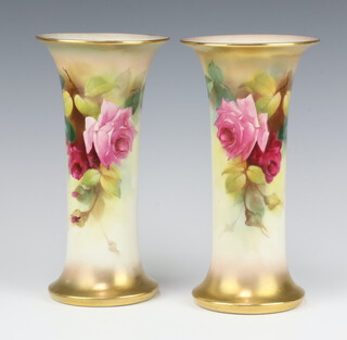 A pair of Royal Worcester cylindrical vases with flared necks decorated with roses, decorated by E Spilsbury no.G923/13.54 23cm 