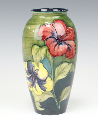 A Walter Moorcroft Hibiscus pattern blue and green ground oviform vase, impressed marks, signature and paper label 25cm 