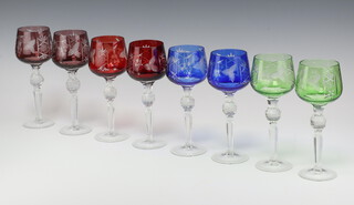 A set of 8 engraved coloured hock wine glasses with faceted stems 20cm 