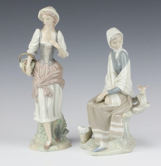 A Lladro figure of a girl carrying a basket of fruits 29cm and a ditto of a girl sitting on a tree stump 25cm  