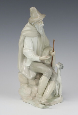 A Lladro figure of a seated gentleman and hound 26cm 