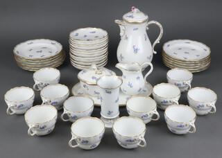 A 20th Century Meissen coffee service comprising 12 coffee cups, 12 saucers, coffee pot and lid, cream jug (chipped), sugar bowl and lid, oval dish, cylindrical vase and 12 small plates, all decorated with spring flowers and with gilt rims 